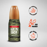 Bottle of Gun Oil with labels indicating compatibility and features on a gray background