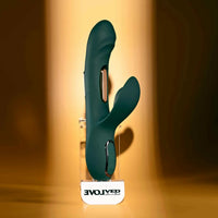 Green silicone vibrator on a stand with 'Evolved' branding against a warm-toned background