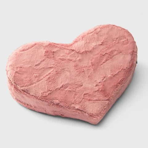 Heart-shaped pink cushion on a light gray background