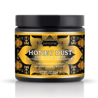 Jar of 'Honey Dust' kissable body powder with decorative label on a white background. coconut pineapple