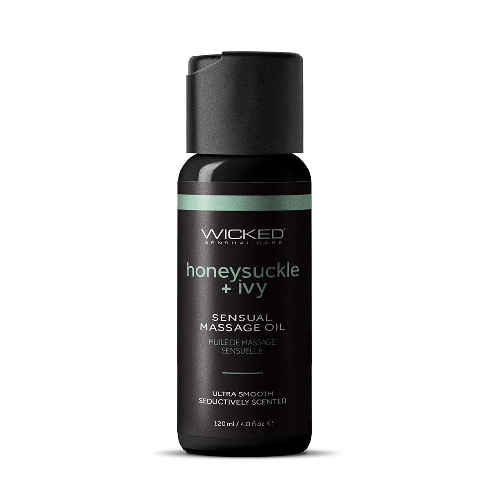 Serum bottle labeled 'wicked sensual massage oil honeysuckle & ivy' on a white background