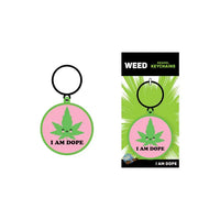 The image displays the "I am Dope" Keychain by Wood Rocket, featuring a colorful design with a cannabis leaf and the phrase "I am Dope" on a circular metal keychain, presented on a branded backing card.