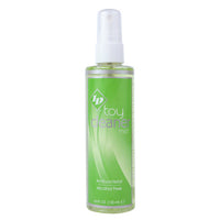 Green bottle of toy cleaner with white cap on a white background