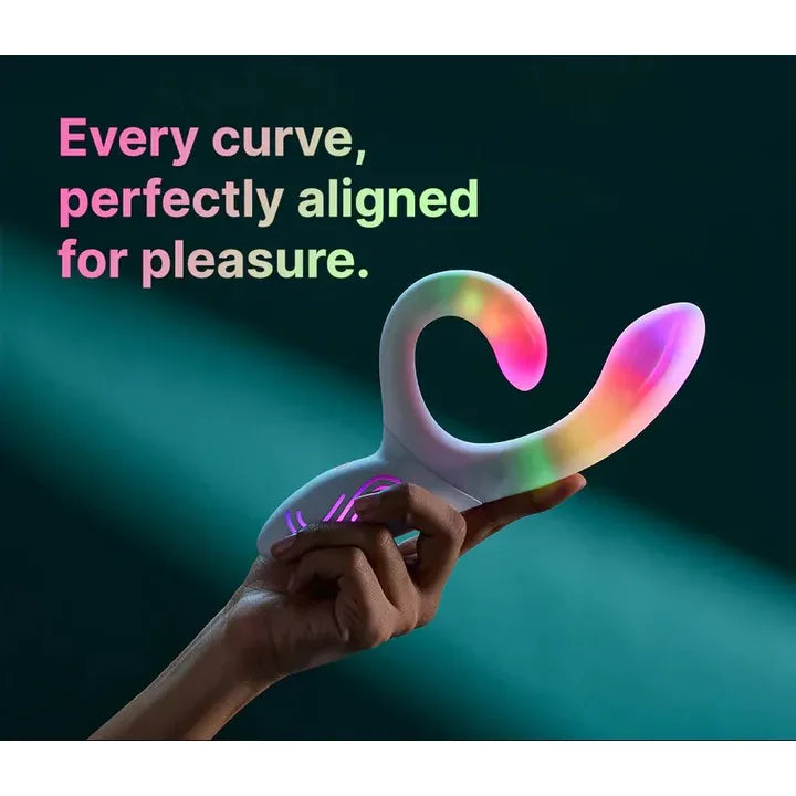 Colorful curved illumination rabbit vibrator held by a hand with text 'Every curve, perfectly aligned for pleasure.' on a dark background