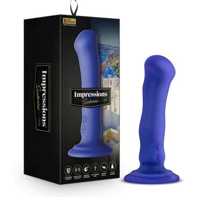 a blue vibrator with a wavy shaft, a bulbus head and a suction cup base shown next to its black display box