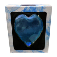 Blue heart-shaped object in a box with a white and blue marbled design.