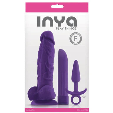 a pink and white display box depicting a purple toy kit. There is a detailed penis shaped dildo with balls and a suction cup, a pointed tip vibrator and an anal plug with a flared base and a finger ring pull