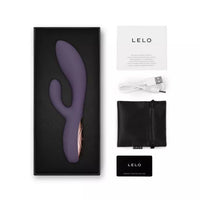 Purple vibrator with LELO branding, including packaging, USB cable, and pouch on a white background.