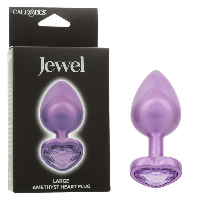 purple large anal plug with heart shaped bottom with purple gem beside box packaging