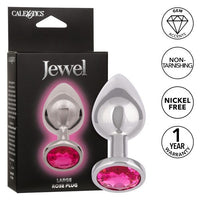 The product image shows a large, teardrop-shaped anal plug with a bright pink gem accent at the base. The plug is made of a shiny, metallic material.