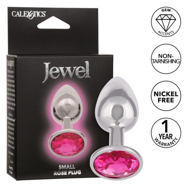 The product image shows a small, sleek anal plug with a pink gem accent. The plug is displayed both out of its package and in the hands of a model, highlighting its design and the gem accent.