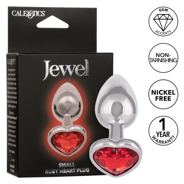 The product image shows a small, heart-shaped anal plug with a red gem accent. The plug is made of a shiny, metal material and is featured in its packaging, which highlights its non-tarnishing and nickel-free qualities.