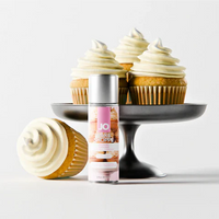 Cupcakes with white frosting on a black cake stand next to a bottle of JO frosted cupCake lube on a light gray background