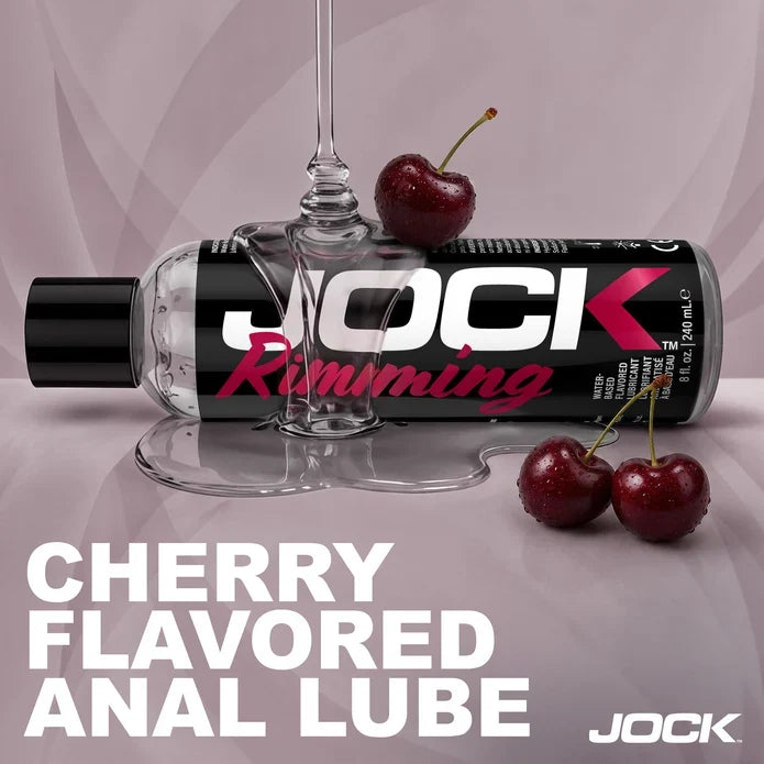 Jock Cherry Flavored Anal Lube with lub pouring and cherries on a light purple background