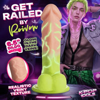 Sexually explicit promotional graphic featuring a realistic dildo product centered on a dark purple background, with a male model partially visible on the right and text overlays including 'GET RAILED BY Reivven', '6.5" DILDO', 'GLOW IN THE DARK VEINS!', and 'REALISTIC VEINY TEXTURE'.