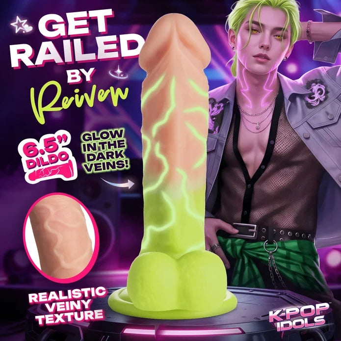 Sexually explicit promotional graphic featuring a realistic dildo product centered on a dark purple background, with a male model partially visible on the right and text overlays including 'GET RAILED BY Reivven', '6.5" DILDO', 'GLOW IN THE DARK VEINS!', and 'REALISTIC VEINY TEXTURE'.