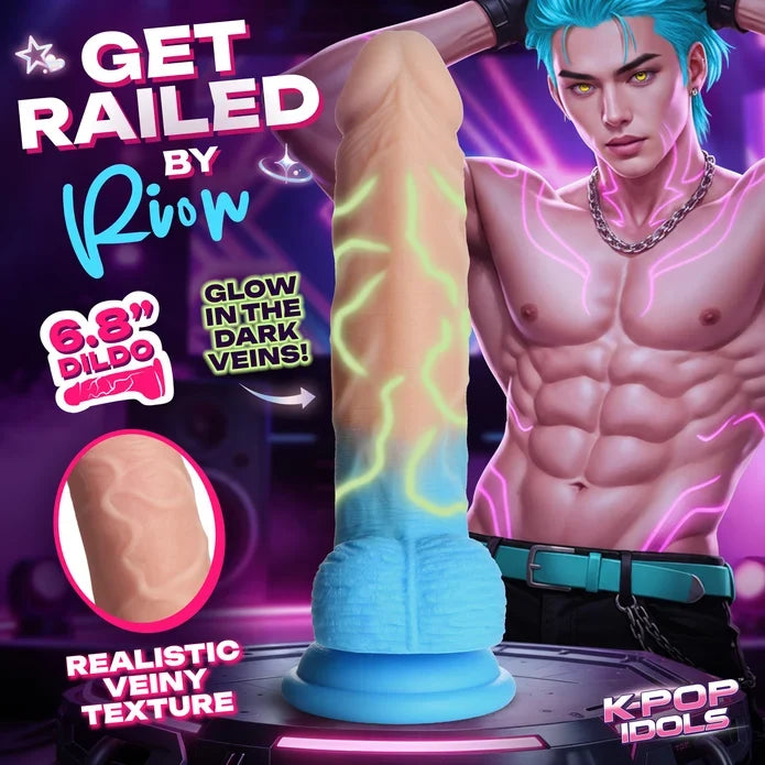 A promotional graphic for an adult novelty product showing a realistic dildo centered on a dark stage-like surface, with a muscular male model partially visible behind it. Large text reads 'GET RAILED BY Rion,' '6.