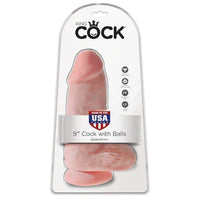 a chubby beige detailed penis shaped dildo with balls and a suction cup. It is shown in its plastic packaging.