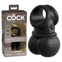 black cock ring with attached vibrating balls next to king cock package