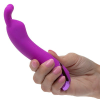 Purple silicone kroma turbo bunny vibrator held by a hand with pink nail polish on a white background