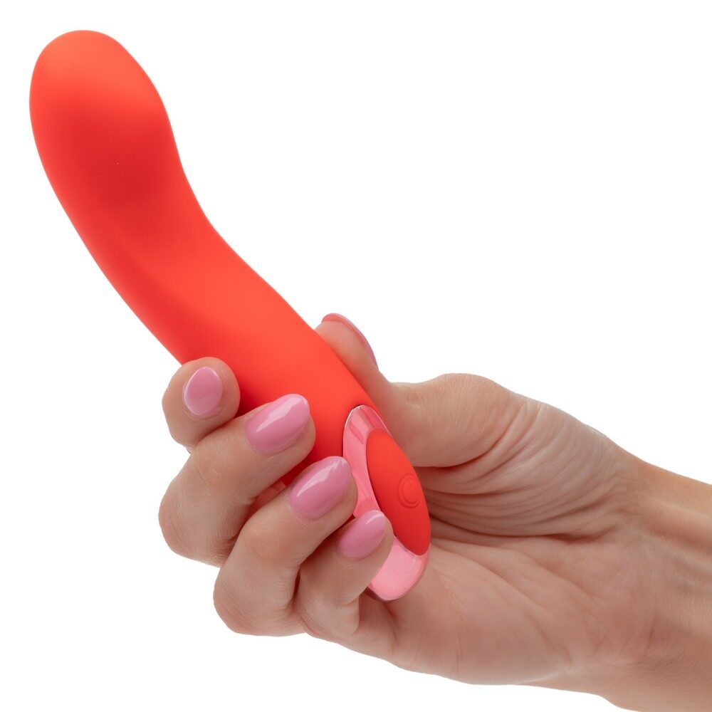 Hand holding a red silicone kroma turbo curve virbator against a white background