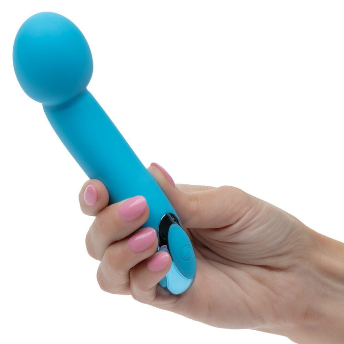 Hand holding a blue massage tool against a white background