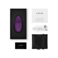 purple hand held massager with box packaging and accessories with lelo branding