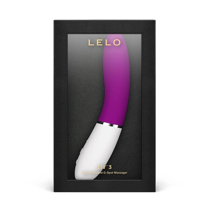 purple vibrator with white handle curved, charging cord, information pamphlet, and storage bag
