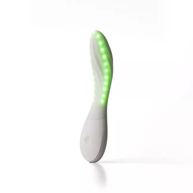 A white curved handheld device with a row of glowing green LED lights along its upper surface, standing upright on a clean white background.