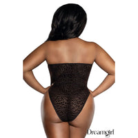 Woman wearing a black leopard print bodysuit on a white background