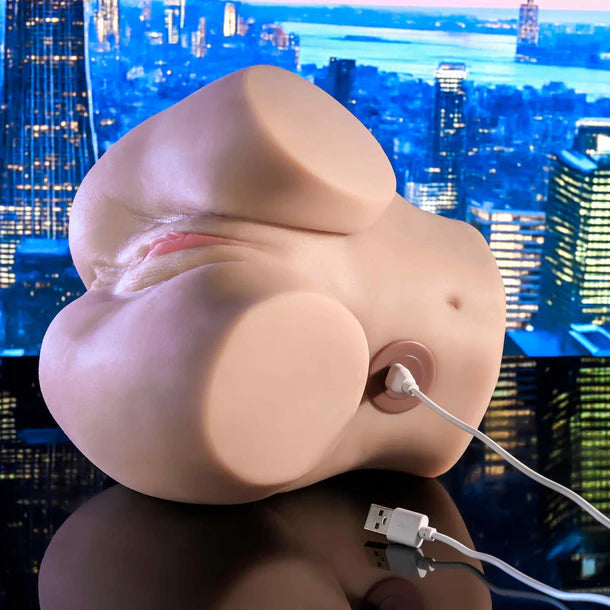 A beige, flesh-toned adult novelty device with a USB charging port, shown with a white USB cable plugged in against a blue-toned city skyline background.