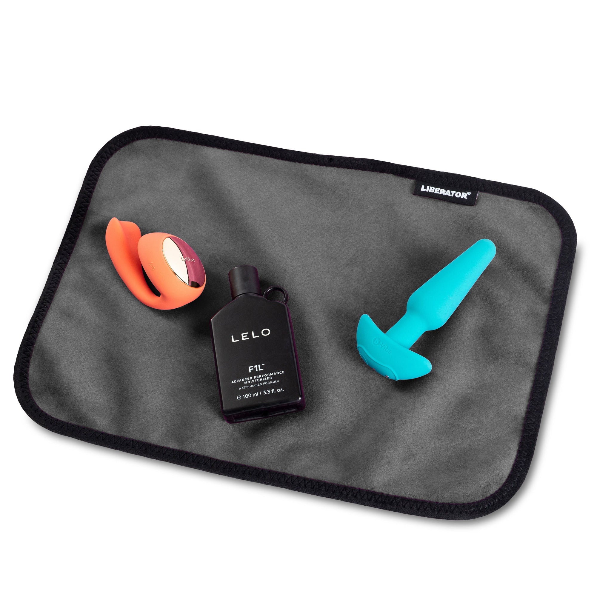 black liberator drying toy mat, with products laying on it. 
