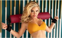 a woman showing how to use the spreader bar on shoulders