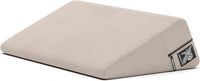cream wedge pillow with a liberator logo on a white background