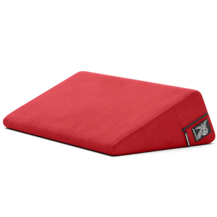 red wedge pillow with a liberator logo on a white background