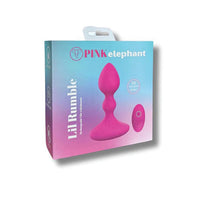 Pink elephant Lil Rumble adult novelty product in its retail packaging, featuring a bright pink silicone plug and suction cup toy on a blue-to-pink gradient box.