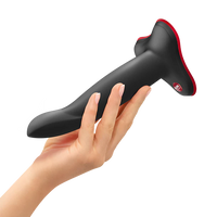 Black and red limba flex m dildo held by a hand on a white background