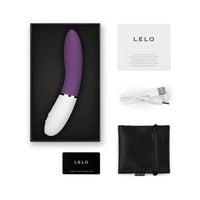 purple vibrator with white handle curved, charging cord, information pamphlet, and storage bag