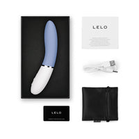 powder blue vibrator with white handle curved, charging cord, information pamphlet, and storage bag