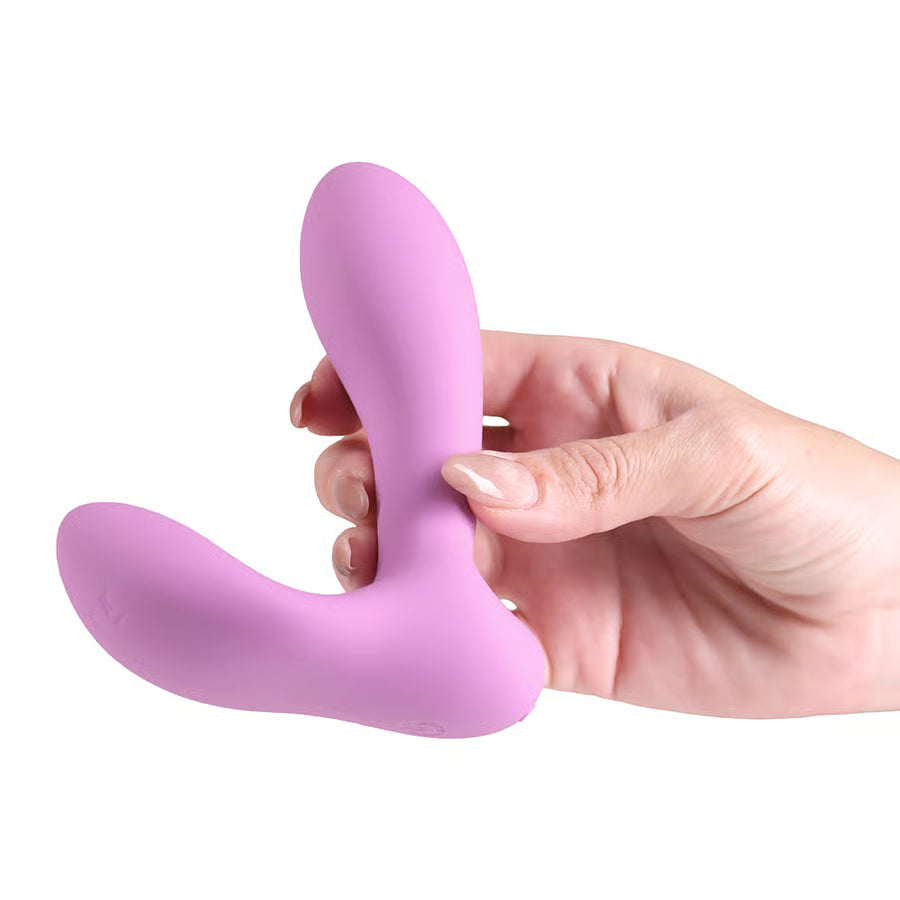 pink dual stimulation vibrator held in hand