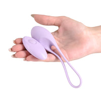 purple vibrating egg with remote held in hand