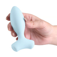 blue vibrating anal plug with bottom base feet held in hand