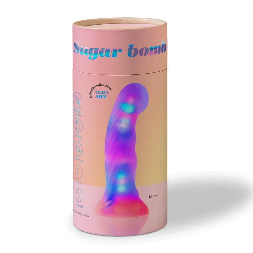 A cylindrical pink product package labeled 'Sugar bomb' with a colorful LED-lit dildo graphic on the front, photographed on a clean white background.