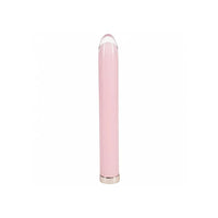 A sleek, minimalist pink glass vibrator device with a glossy finish, featuring a clear rounded top and a metallic silver base, set against a solid white background.