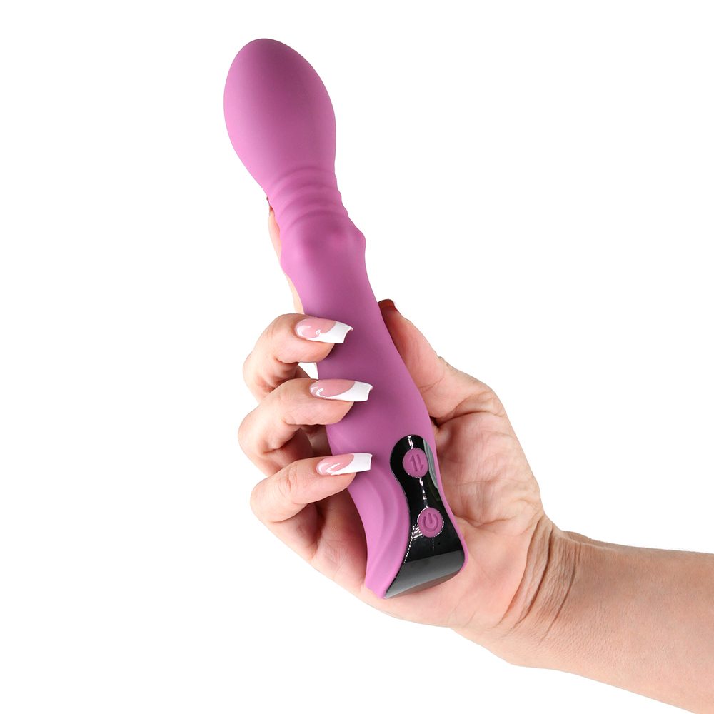 Hand holding a purple cadence thrusting vibrator  against a white background