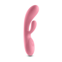 Pink silicone vibrator with clitoral stimulator on a white background