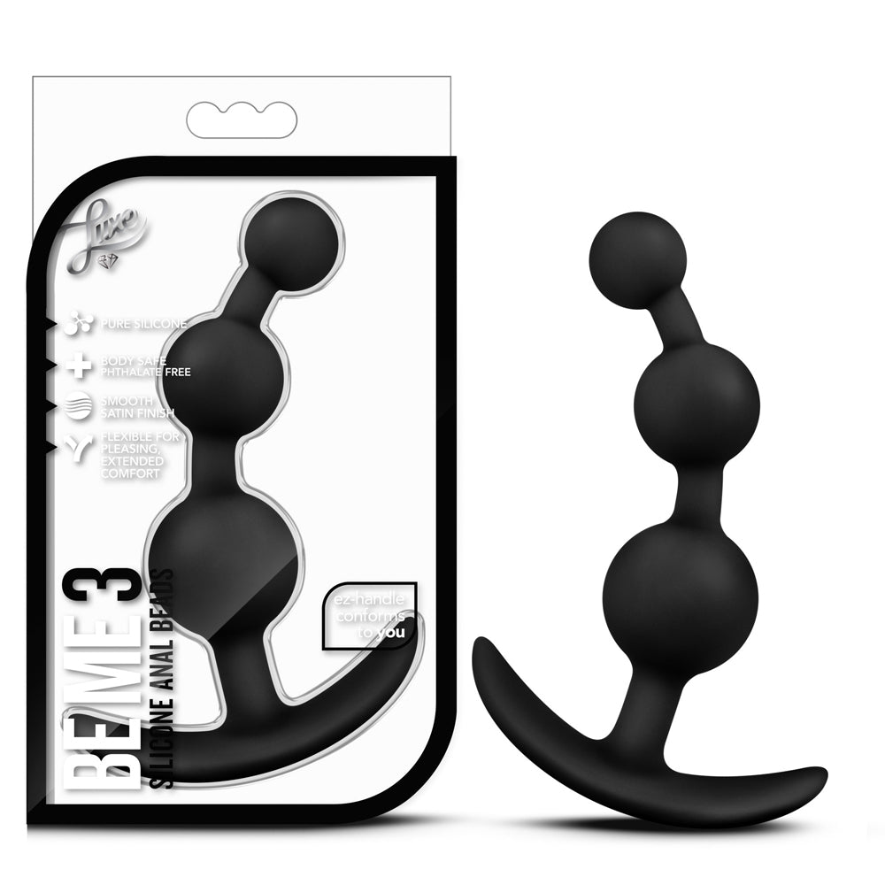 Black silicone butt plug with packaging on a white background