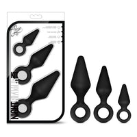 3 black anal plugs with finger ring holders beside box packaging