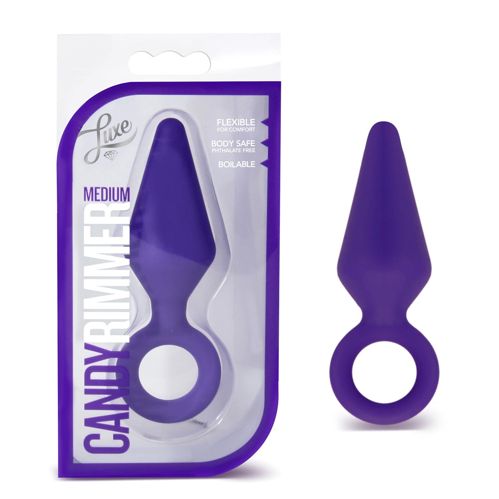 purple anal plug with finger ring holder beside box packaging