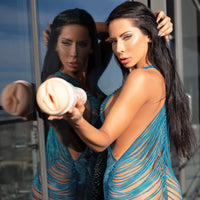 madison ivy wearing  blue lingerie standing in front of a window holding a fleshlight